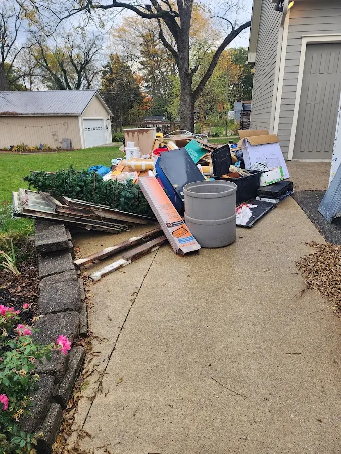 Dumpster being loaded with debris for 10 Yard Dumpster Rental in Suffolk
